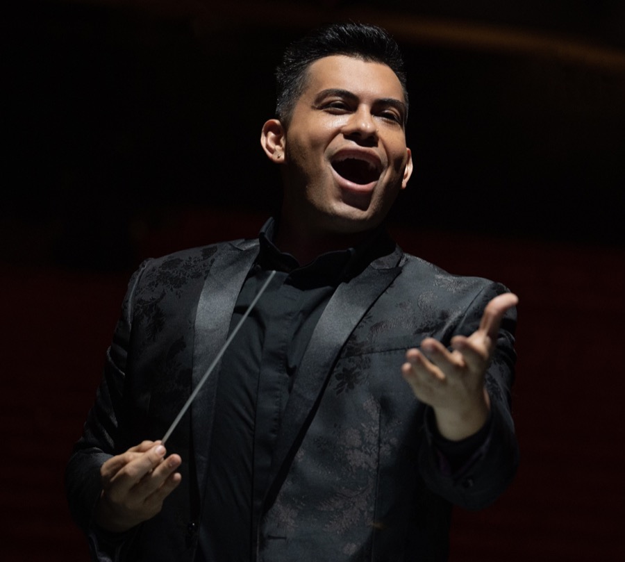 Gabe Salazar conducting in a black jacket.